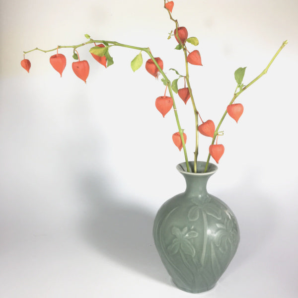Porcelain floral vase with in celadon glaze